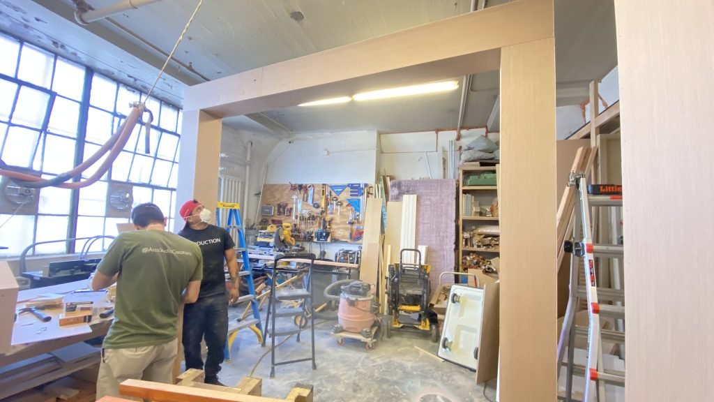 A rectangular scenic frame with an open center inside a workshop.