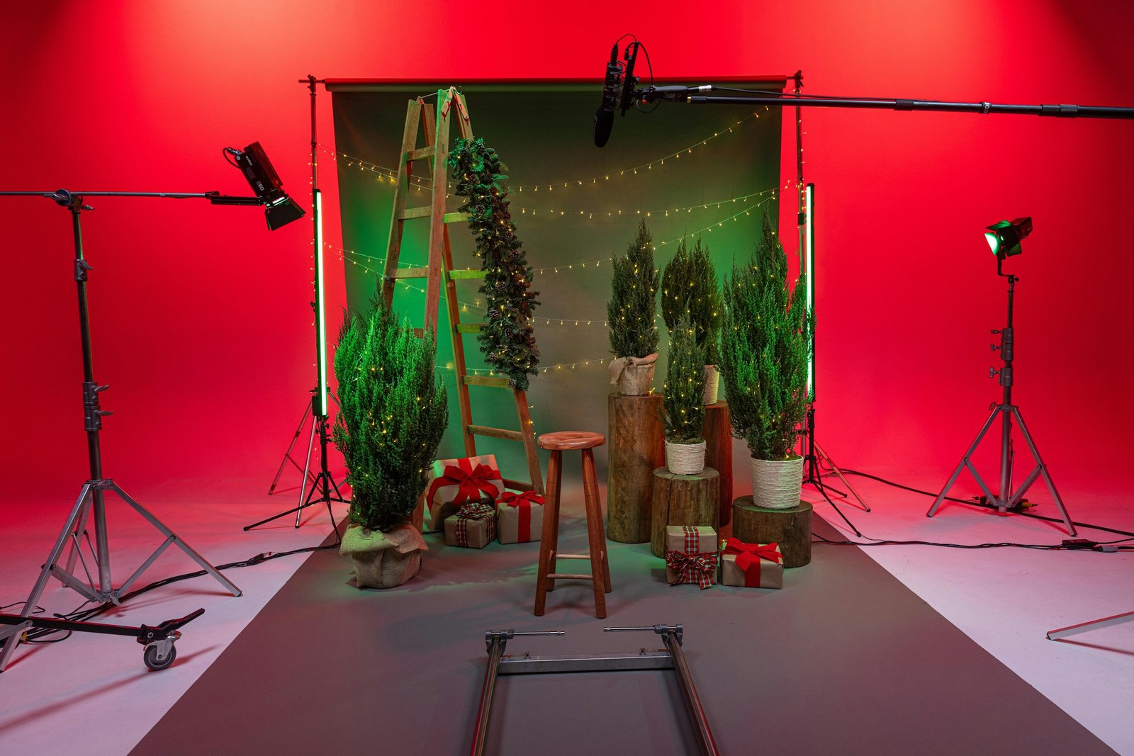 Christmas photo set with greenery, wrapped gifts and studio equipment